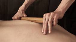 bamboo stick being used for massage